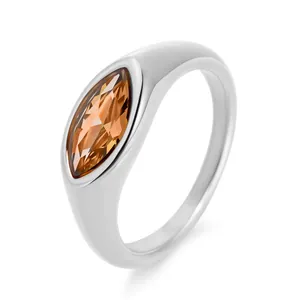 Macro shot of silver ring with marquise-cut champagne zircon on polished stainless steel