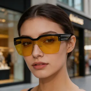 Détails de lunettes de soleil demi-cerclées oversize avec verres jaunes sur un mannequin