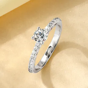 Macro shot of 14k gold plated moissanite ring with four-prong setting and side diamonds