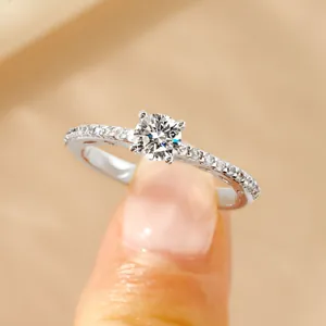 Macro view of 14k gold-filled moissanite ring with four-prong set round diamond detail