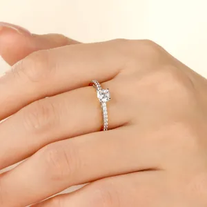 Close-up of a 14k gold-filled moissanite ring featuring a classic six-prong setting