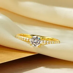 Macro detail of 14k gold-filled moissanite ring with round solitaire and pavé diamond band