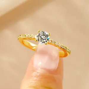 Detailed macro view of a 14k gold plated ring with round brilliant cut moissanite setting