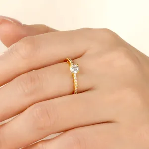 Macro detail of 14k gold-filled moissanite ring showing brilliant pavé-set side stones