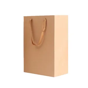 Vertical brown kraft paper shopping bag with flat ribbon handles for premium gift packaging