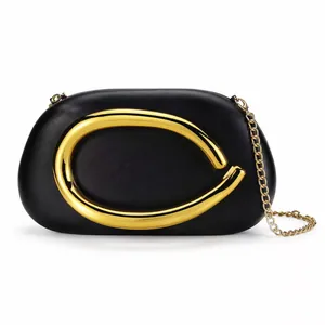 Modern black shell-shaped acrylic evening clutch with gold metal horseshoe hardware