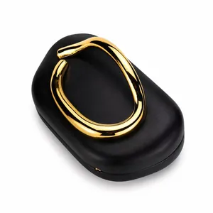 Detailed macro view of black leather clutch with golden sculptural metal handle