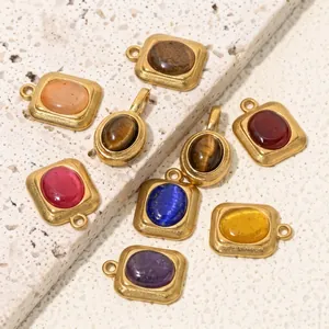 Detailed view of handmade oval and square natural stone pendants with gold metal frames