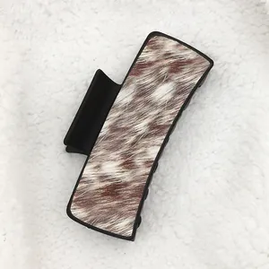 Western cowboy style hair claw clip featuring brown faux fur animal print on white sherpa