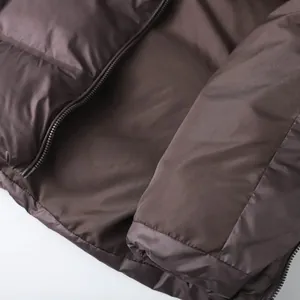 Women's dark brown sleeveless quilted puffer vest with sleek metallic zipper detail