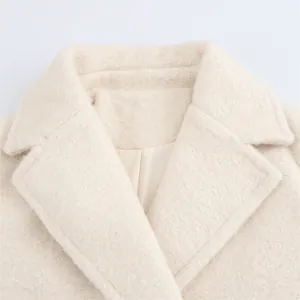 Detail of elegant notched lapel on cream textured wool coat with premium lining