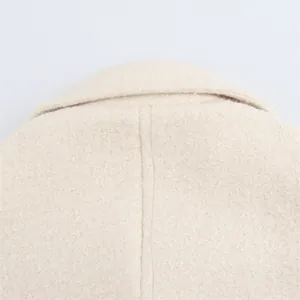 Detailed view of beige boucle wool collar and premium stitching on the back of the coat