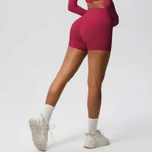 Detail view of deep red moisture-wicking yoga set featuring high-waist shorts and crop top