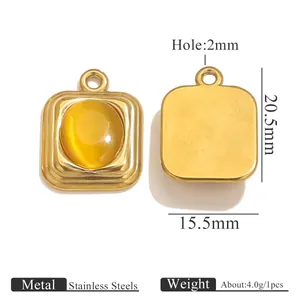 Macro view of oval stainless steel pendant with yellow gemstone insert showing dimensions