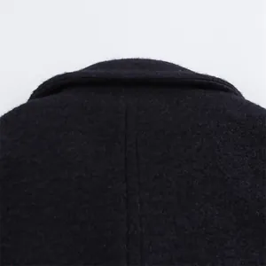 Detailed texture of dark textured wool coat fabric with lapel collar stitching