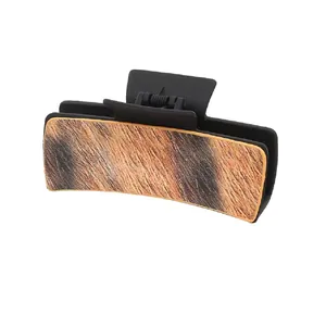 Western cowboy style hair claw clip featuring faux horsehair leather texture on matte black base
