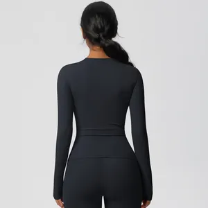 Rear view of black long-sleeved compression yoga top featuring slim fit and matte finish