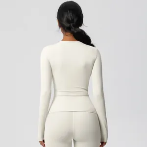 Back view of cream high-stretch long sleeve yoga top and matching leggings fitness set