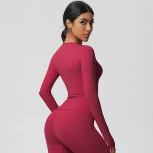Detail view of burgundy brushed compression yoga set featuring long sleeve top and leggings