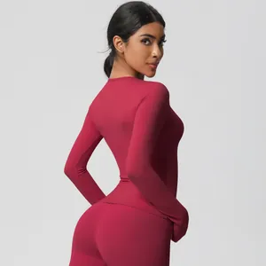 Detail view of burgundy yoga set featuring high-waisted leggings and slim fit long sleeve top