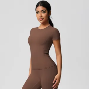 Close-up of slim fit short sleeve top and high waist yoga leggings in dark brown fabric