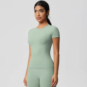 Close-up of sage green brushed yoga set featuring short sleeve top and high waist leggings