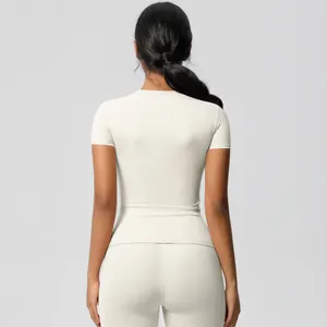Rear view of slim fit cream yoga set showing high waist leggings and short sleeve top