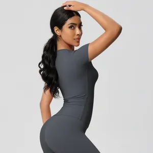 Detail view of the high-stretch matte fabric and slim fit on dark gray yoga set