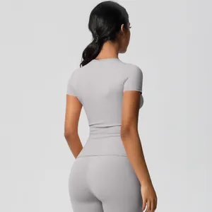 Back view of slim-fit grey yoga set showing compression and sculpting athletic fabric