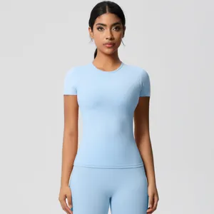 Front view of women's tight light blue yoga set with short sleeve top and leggings