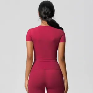 Detail view of burgundy yoga set featuring slim fit short sleeve top and high waist leggings