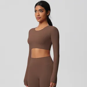 Detail view of chocolate brown two-piece yoga set featuring long sleeve crop top and leggings