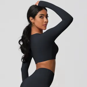 Detail view of the high-waisted leggings and cropped long-sleeve black yoga set back view