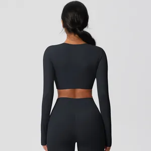 Back view of black long-sleeve crop top and tight yoga leggings with high elasticity