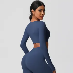 Detail of dark blue yoga set showing high-waist leggings and long sleeve crop top back