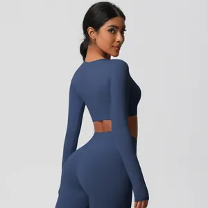 Detail view of high-waist yoga leggings and crop top showing stretch fabric fit