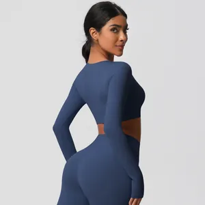 Detail view of high-waist yoga leggings and long sleeve crop top in navy blue