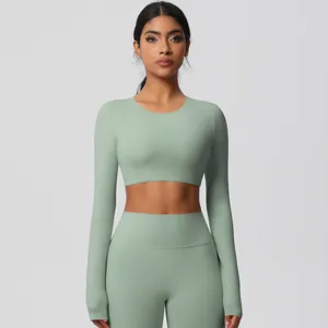 Detail of high-waist sage green yoga set with long sleeve crop top for fitness