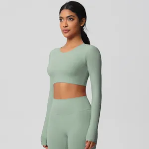 Close-up of sage green seamless yoga set with long sleeve crop top and high waist leggings