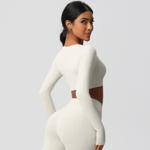 Close-up of cream white yoga set with high-waist leggings and long-sleeve crop top