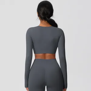 Back view of slim fit dark grey yoga set with long sleeve crop top and high waist leggings