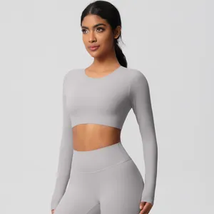 Detail of high-waisted seamless leggings and cropped long sleeve yoga set in cold grey