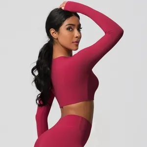 Detail view of burgundy tight-fit yoga set showing brushed texture and athletic cut
