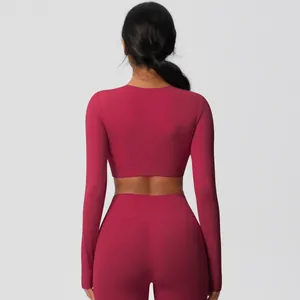 Back view of pink two-piece yoga set showing slim fit long sleeve top and leggings
