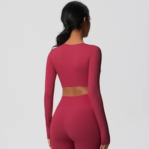 Back view of burgundy yoga set featuring high-waisted leggings and long sleeve crop top
