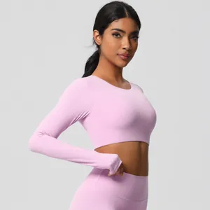 Detail of pink long sleeve crop top and high waist yoga leggings with elastic fabric