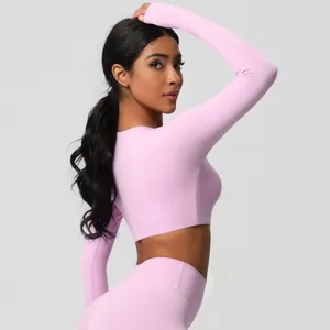 Close-up of pink long sleeve crop top and leggings showing seamless knit texture