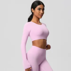 Side view of pink long sleeve crop top and high waist yoga leggings set for women
