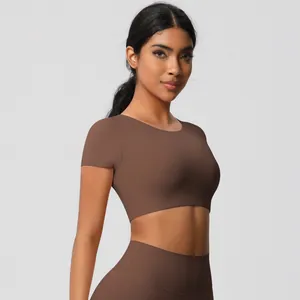 Close-up of brown brushed yoga crop top and high-waisted leggings on a model