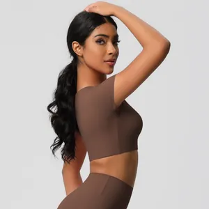 Detail showing the seamless knit texture of the coffee brown crop top and yoga pants